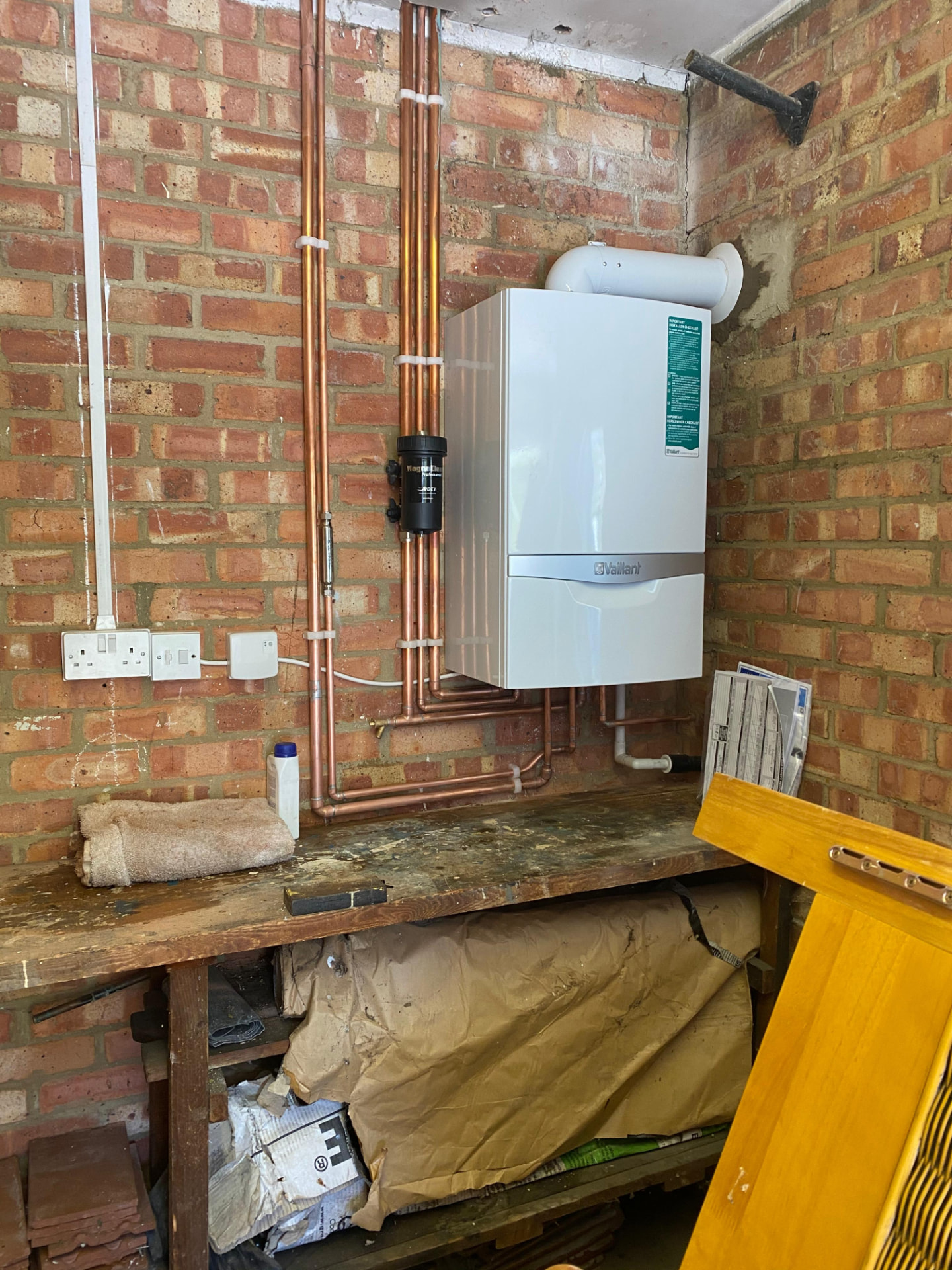 Vaillant boiler installed on a brick wall with magnetic system filter